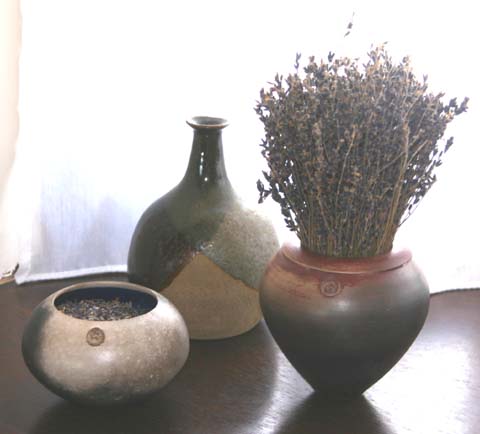 My bottle lurking behind two of Hughs wonderful raku pots