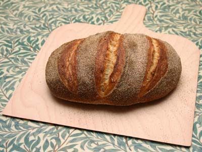 The first loaf out of the oven on its peel